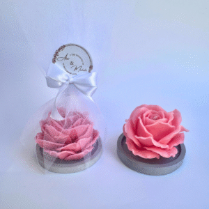 Website image description: pink scented candle in a shape of rose sitting on a wooden coaster in white mesh with custom label , perfect as wedding gift and door gift